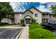 Well-maintained condo building with manicured landscaping and visible parking spots on a sunny day at 246 Legends Creek Way # Apt 207, Indianapolis, IN 46229
