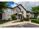 Inviting condo exterior with mature trees, landscaping, and visible parking in a well maintained community at 246 Legends Creek Way # Apt 207, Indianapolis, IN 46229