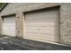Convenient two-car garage showcasing sturdy doors, offering practicality and security at 246 Legends Creek Way # Apt 207, Indianapolis, IN 46229