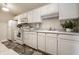 Bright kitchen featuring white appliances, cabinetry, and sleek countertops for efficient meal preparation at 246 Legends Creek Way # Apt 207, Indianapolis, IN 46229