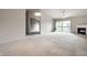 Bright living room featuring plush carpeting, a fireplace, and sliding glass doors to a private balcony at 246 Legends Creek Way # Apt 207, Indianapolis, IN 46229