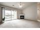 Light-filled living room with a cozy fireplace and sliding glass doors leading to a balcony at 246 Legends Creek Way # Apt 207, Indianapolis, IN 46229
