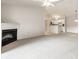 Open-concept living room with a fireplace, flowing into a bright kitchen with white cabinetry at 246 Legends Creek Way # Apt 207, Indianapolis, IN 46229