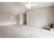 Spacious living room featuring neutral walls, plush carpeting, and a contemporary pendant light at 246 Legends Creek Way # Apt 207, Indianapolis, IN 46229