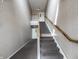 Clean, well-lit carpeted staircase in a building with neutral decor and updated lighting fixtures at 246 Legends Creek Way # Apt 207, Indianapolis, IN 46229