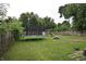 Large backyard featuring a trampoline, swing set, and ample green space for outdoor activities at 2638 S Mcclure St, Indianapolis, IN 46241