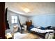 Cozy bedroom featuring light blue walls, a bed, dresser, and natural light from the window at 2638 S Mcclure St, Indianapolis, IN 46241