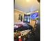 Modest bedroom featuring dark curtained window, wood paneling, and bed with a TV, blending comfort and functionality at 2638 S Mcclure St, Indianapolis, IN 46241