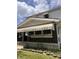 Low angle exterior showcasing the house, including the front porch with awning over windows and steps at 2742 Allen Ave, Indianapolis, IN 46203