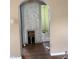Arched doorway reveals interior with hardwood floors and damaged walls ready for renovation at 2742 Allen Ave, Indianapolis, IN 46203