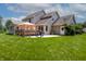 Expansive backyard with well-maintained lawn, patio, and deck, ideal for outdoor living and activities at 2756 Bluebell E Ct, Columbus, IN 47201