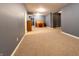 Open basement area with light-blue painted walls, neutral carpet, and a wood desk along the back wall at 2756 Bluebell E Ct, Columbus, IN 47201
