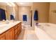 Bathroom with double vanity, bathtub, and tile flooring at 2756 Bluebell E Ct, Columbus, IN 47201
