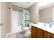 Bathroom with neutral tones, shower-tub with shower curtain, toilet, and a wooden vanity with white basin at 2756 Bluebell E Ct, Columbus, IN 47201