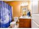 Bright bathroom featuring a single sink vanity with wood cabinets, and a shower/tub combo with moon shower curtain at 2756 Bluebell E Ct, Columbus, IN 47201