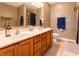 Comfortable bathroom featuring double vanity, tile floor, and framed mirror at 2756 Bluebell E Ct, Columbus, IN 47201