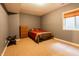Bedroom offers a bed with decorative pillows, a window with blinds, carpet, and a clothing rack at 2756 Bluebell E Ct, Columbus, IN 47201
