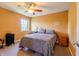 Cozy bedroom with ceiling fan, a double bed with floral bedding, and natural light from a nearby window at 2756 Bluebell E Ct, Columbus, IN 47201