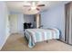 Comfortable bedroom with blue walls, carpeted floor, bed, and ceiling fan at 2756 Bluebell E Ct, Columbus, IN 47201