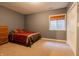 Bedroom features a bed with decorative pillows, a window with blinds, carpet flooring, and a closet at 2756 Bluebell E Ct, Columbus, IN 47201