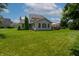 Picture of house featuring green yard and sun room with plenty of windows at 2756 Bluebell E Ct, Columbus, IN 47201