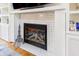 Elegant fireplace with custom shelving, mosaic tile and decorative accents, creating a focal point at 2756 Bluebell E Ct, Columbus, IN 47201