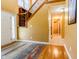 Welcoming foyer with hardwood and carpet flooring, featuring staircase with iron spindles and open layout at 2756 Bluebell E Ct, Columbus, IN 47201