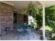 Close up view of a lovely front porch with outdoor furniture and hanging plants, creating a serene ambiance at 2756 Bluebell E Ct, Columbus, IN 47201
