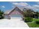 Spacious two-car garage with a brick facade and a paved driveway, complemented by well-maintained landscaping at 2756 Bluebell E Ct, Columbus, IN 47201