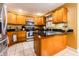Spacious kitchen with stainless steel appliances, stone counters, and wooden cabinets at 2756 Bluebell E Ct, Columbus, IN 47201