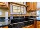 Close-up highlighting the kitchen's custom dark sink with elegant faucet and fixtures at 2756 Bluebell E Ct, Columbus, IN 47201