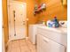Practical laundry room featuring washer, dryer, shelving, and tile flooring at 2756 Bluebell E Ct, Columbus, IN 47201