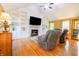Inviting living room featuring built-in shelving, a cozy fireplace, and hardwood floors at 2756 Bluebell E Ct, Columbus, IN 47201