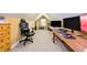 Attic room, an office space, includes a desk, computer equipment, a rolling chair, and storage drawers at 2756 Bluebell E Ct, Columbus, IN 47201
