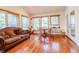 Inviting sunroom with hardwood floors, large windows, and comfortable seating arrangement at 2756 Bluebell E Ct, Columbus, IN 47201