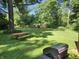 Large, grassy backyard featuring a picnic table and grill, perfect for outdoor entertaining at 2808 Woodside Dr, Plainfield, IN 46168