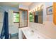 Cozy bathroom with blue accents, white tile, and a mirrored vanity with unique towel storage and a shower curtain at 2808 Woodside Dr, Plainfield, IN 46168