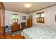 Inviting bedroom with hardwood floors, lots of natural light, and cozy decor with a patterned bedspread at 2808 Woodside Dr, Plainfield, IN 46168