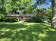 Charming brick ranch home with a lush green lawn and mature trees at 2808 Woodside Dr, Plainfield, IN 46168