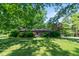 Charming brick ranch home with well-maintained lawn and mature trees at 2808 Woodside Dr, Plainfield, IN 46168