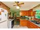 Functional kitchen with wooden cabinetry overlooking cozy dining area at 2808 Woodside Dr, Plainfield, IN 46168