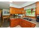 Functional kitchen with wooden cabinetry overlooking cozy dining area at 2808 Woodside Dr, Plainfield, IN 46168