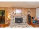 Close up of cozy stone fireplace and wood paneling in living room at 2808 Woodside Dr, Plainfield, IN 46168