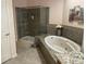 Bathroom features a large tub, granite countertops, and a tiled walk in shower at 3154 Beach Blvd, Cicero, IN 46034