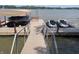 Dock featuring boat lift and jet ski parking on a calm lake at 3154 Beach Blvd, Cicero, IN 46034