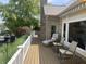 Spacious deck with lounge chair and rockers, overlooking serene, wooded landscape at 3154 Beach Blvd, Cicero, IN 46034