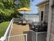 Inviting deck with dining area, featuring lake views and umbrella shade at 3154 Beach Blvd, Cicero, IN 46034