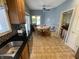 The eat-in kitchen nook features blue walls, neutral floor tiles, built-in benches, and a view through the window to the yard at 3154 Beach Blvd, Cicero, IN 46034