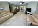 Spacious living room features neutral walls and carpet, with ample seating and access to multiple rooms within the home at 3154 Beach Blvd, Cicero, IN 46034