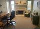 Comfortable home office setup featuring a fireplace, desk, and views of the lake, offering a serene workspace at 3154 Beach Blvd, Cicero, IN 46034